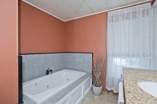 a bathroom with a tub and sink