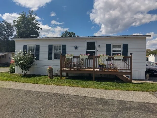 a view of a house with a yard and plants