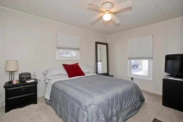 a bedroom with a bed and a tv on a dresser
