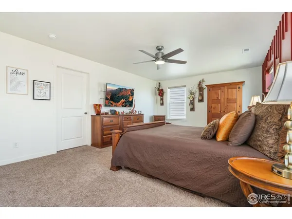 a view of a bedroom with a table and a chair