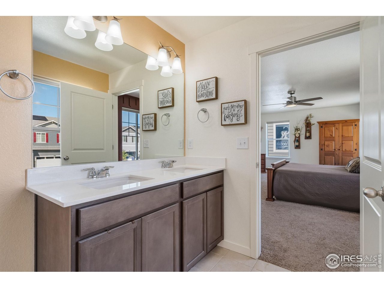 1233 Lily Mountain Road Severance, CO 80550 - Photo 21 of 44 a en suite bathroom with a sink double vanity granite and a mirror
