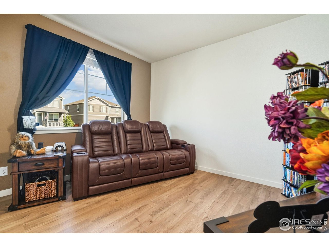 1233 Lily Mountain Road Severance, CO 80550 - Photo 7 of 44 a living room with furniture a flat screen tv and a floor to ceiling window