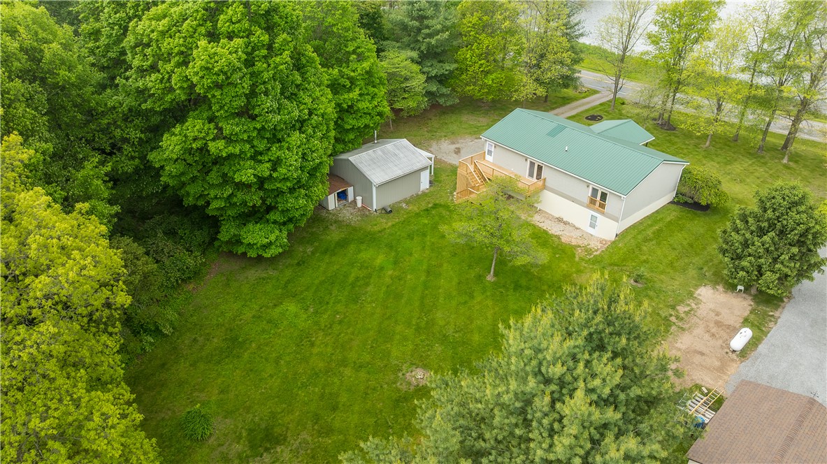 1319 Perry Road Cable, OH 43009 - Photo 43 of 44 Perched on a sprawling lot, this charming home offers abundant green space and a serene, natural setting.