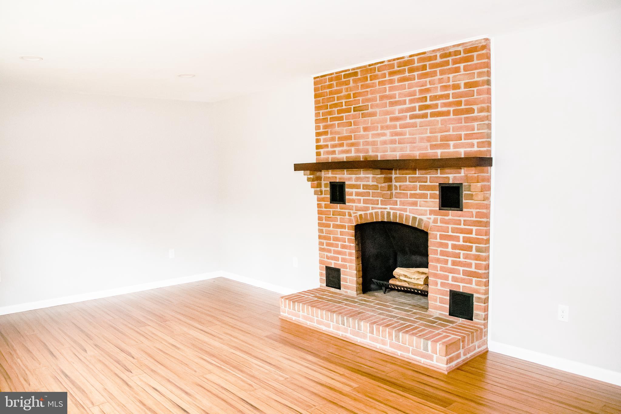 21398 Tanyard Road Preston, MD 21655 - Photo 13 of 27 Living room with masonry brick fireplace