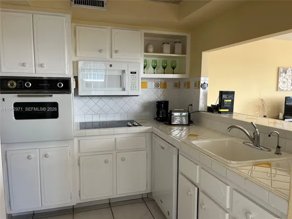 a kitchen with cabinets appliances and a sink