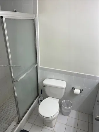 a white toilet sitting next to a sink