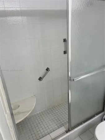 a bathroom with a granite countertop toilet