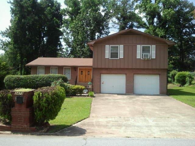 3473 Springrun Drive Decatur, GA 30032 - Photo 1 of 1 a front view of a house with a yard and garage