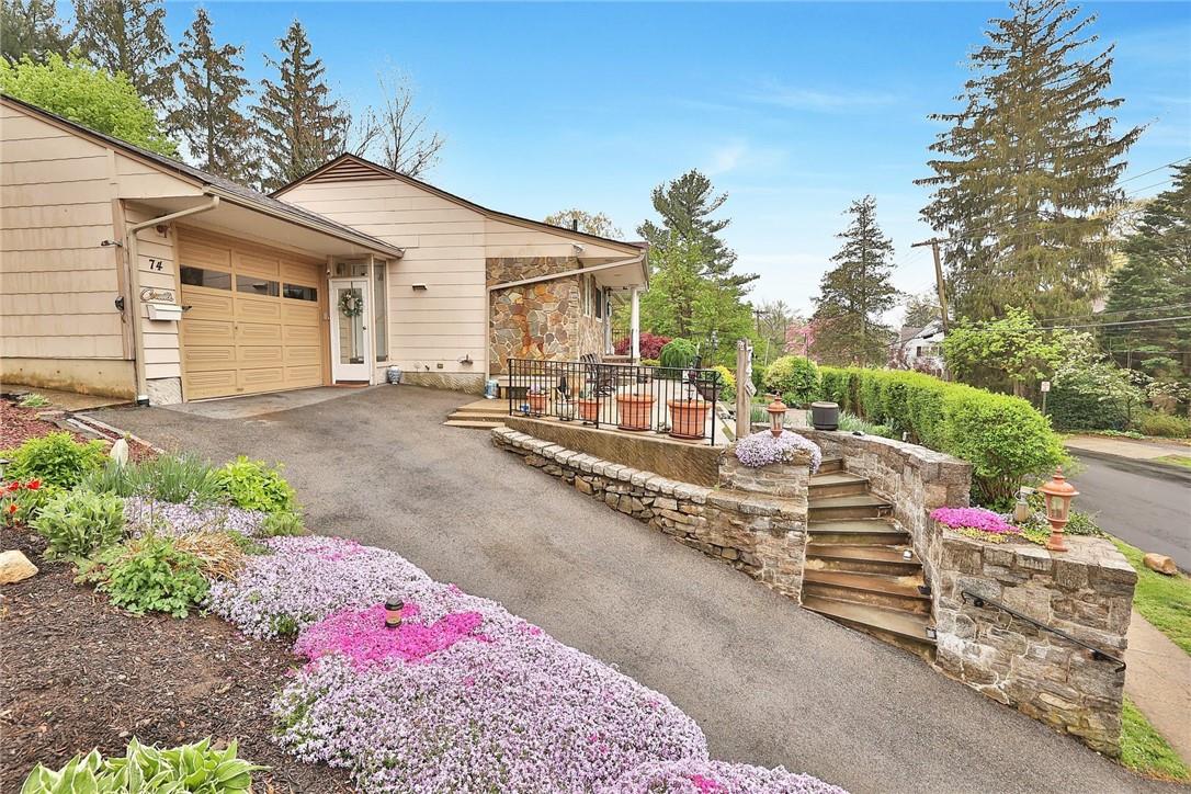 a view of a house with backyard and sitting area
