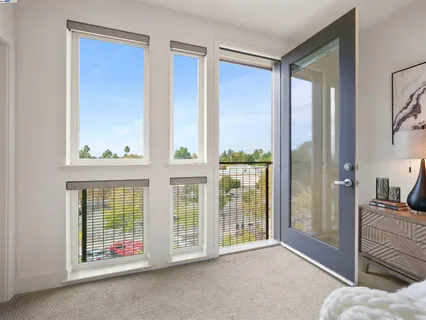 a view of a bedroom with furniture and windows