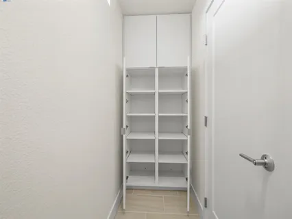 a view of walk in closet with empty racks