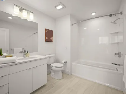 a bathroom with a toilet a sink a mirror a bathtub and vanity