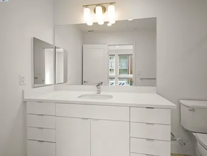 a bathroom with a sink vanity and a mirror