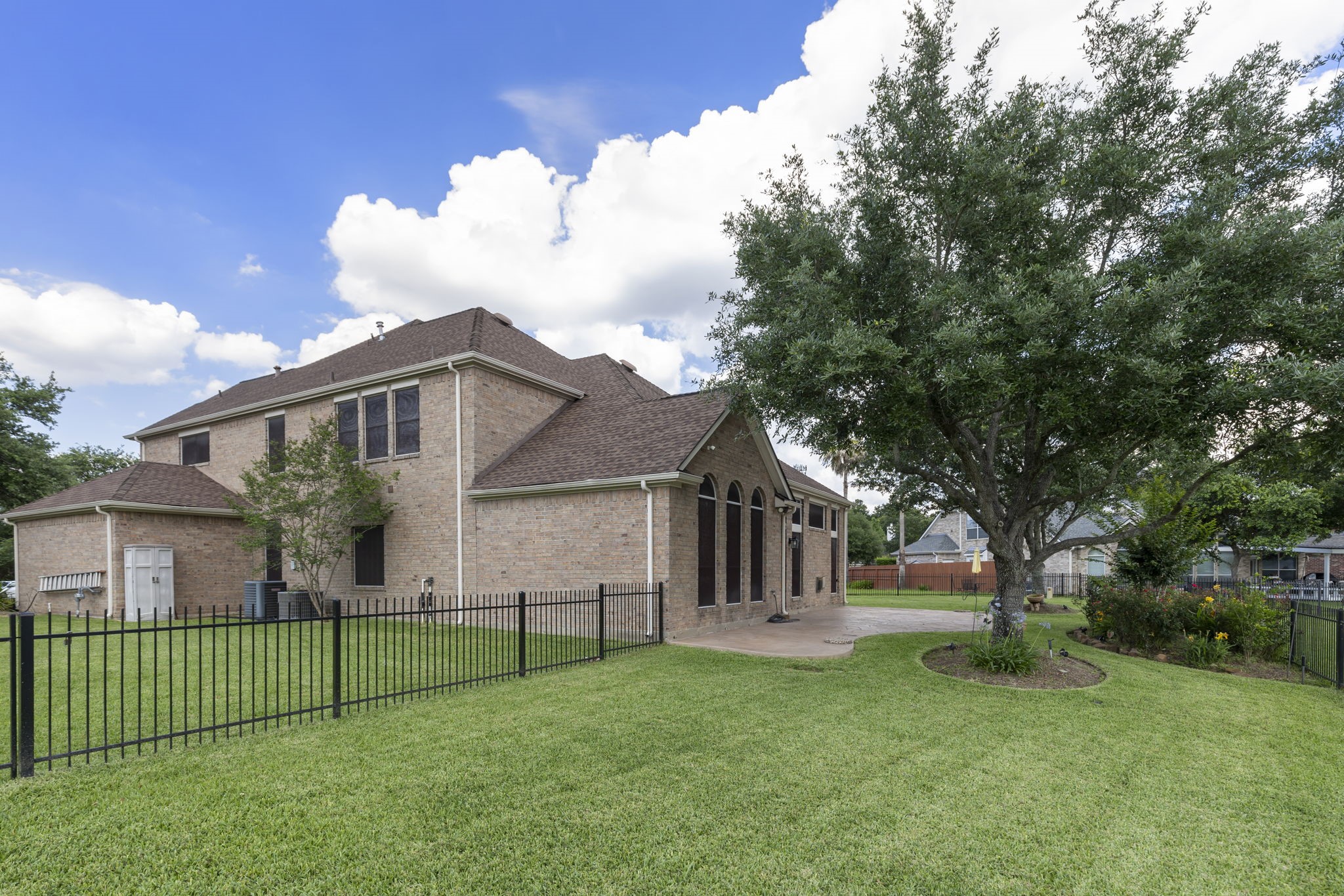 2907 Stemwood Drive Spring, TX 77388 - Photo 31 of 33 Beautiful brick exterior surrounded by mature trees, manicured landscaping, and a fully fenced backyard. This spacious waterfront lot offers an extended patio and expansive green space perfect for outdoor living and entertaining.