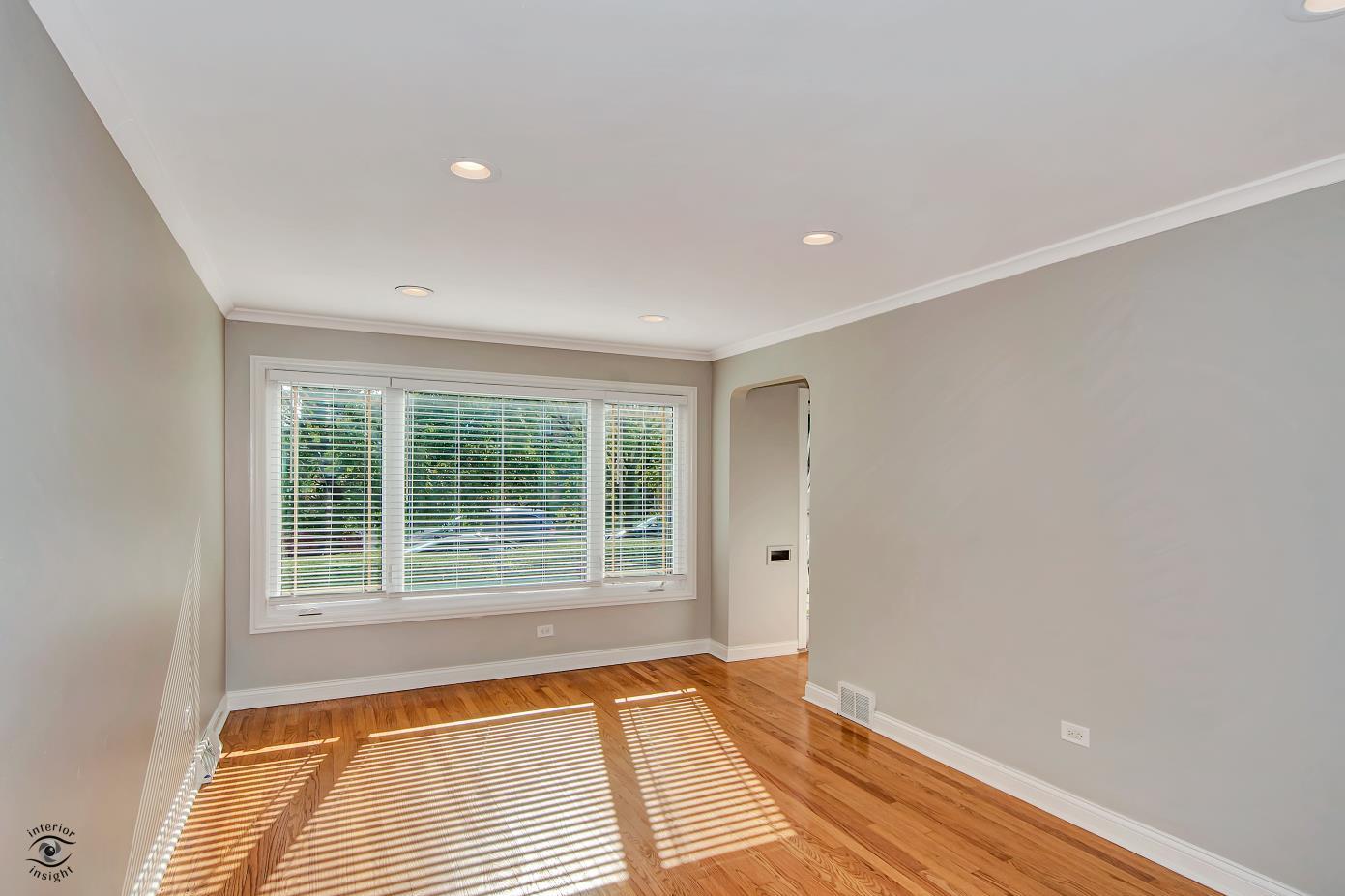 10348 South Rhodes Avenue Chicago, IL 60628 - Photo 2 of 20 a view of an empty room with wooden floor and a window