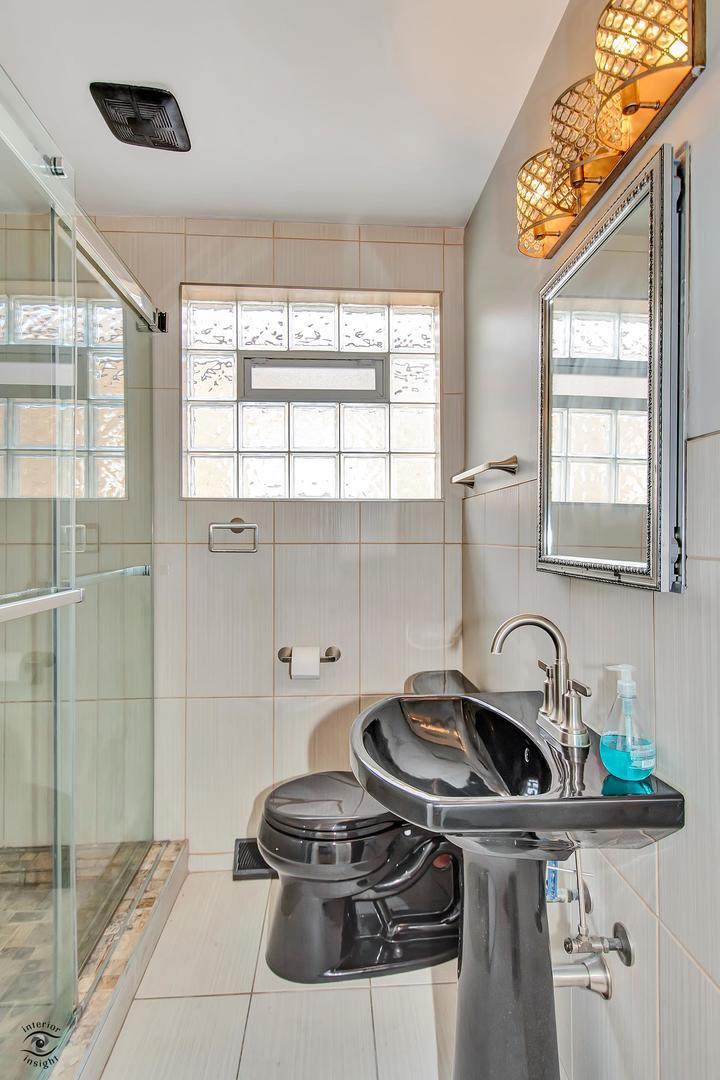 10348 South Rhodes Avenue Chicago, IL 60628 - Photo 5 of 20 a kitchen with a sink a stove and a window