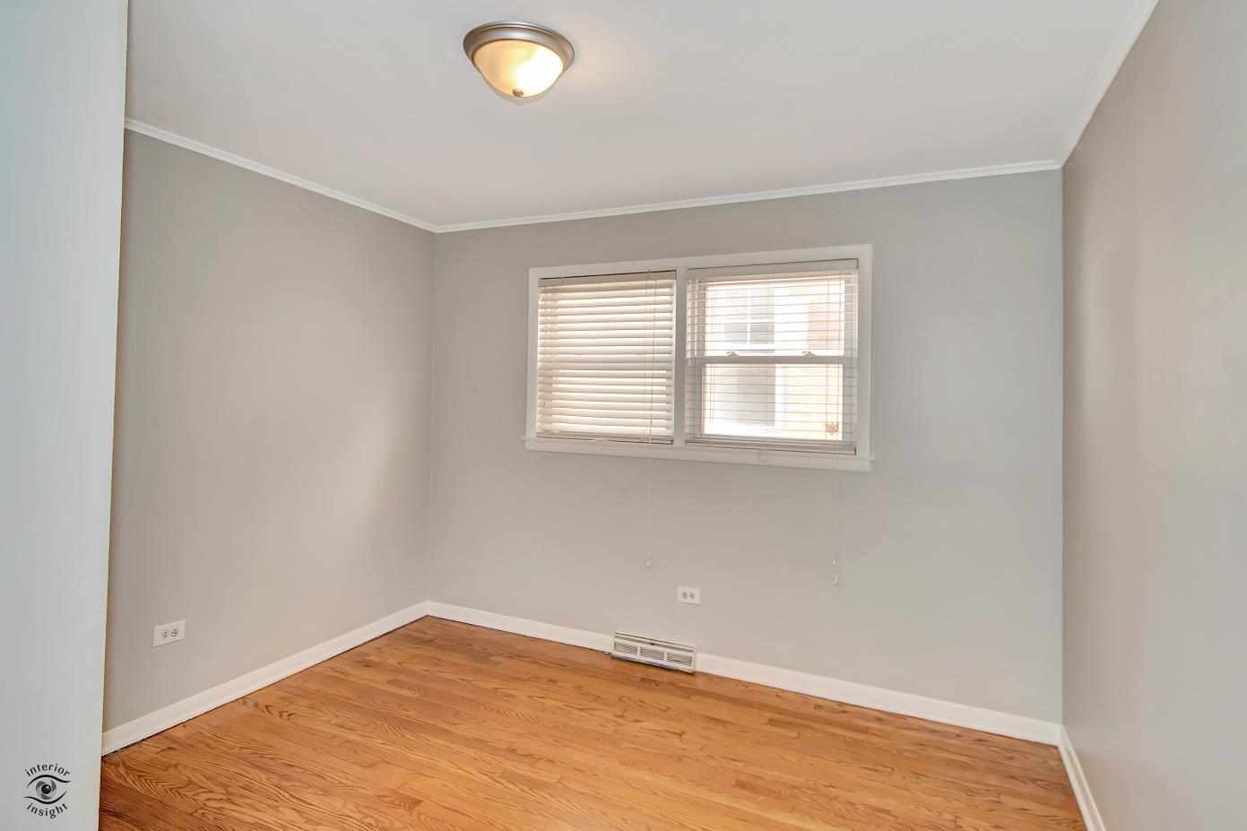 10348 South Rhodes Avenue Chicago, IL 60628 - Photo 7 of 20 an empty room with a window