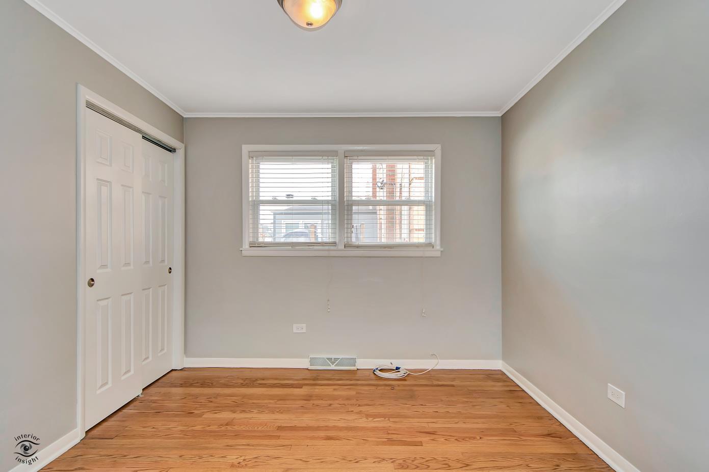 10348 South Rhodes Avenue Chicago, IL 60628 - Photo 9 of 20 an empty room with window