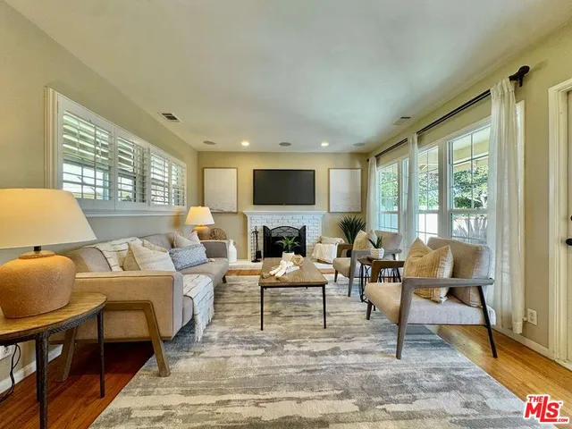 a living room with fireplace furniture and a flat screen tv