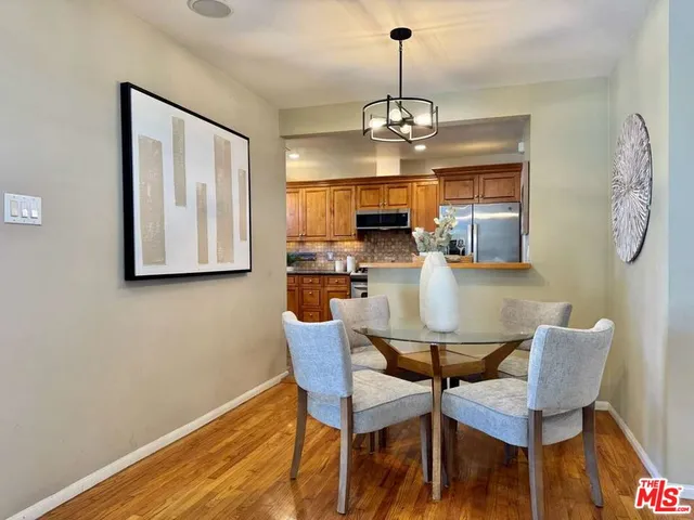 a view of a dining room with furniture wooden floor and chandelier