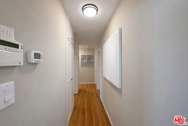 a view of a hallway with wooden floor and staircase