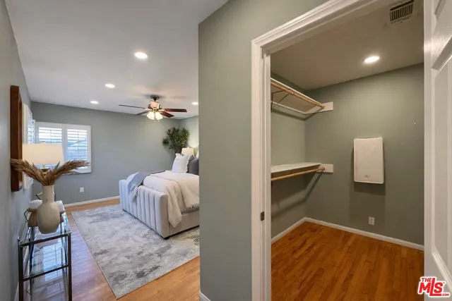 a view of a bedroom with wooden floor