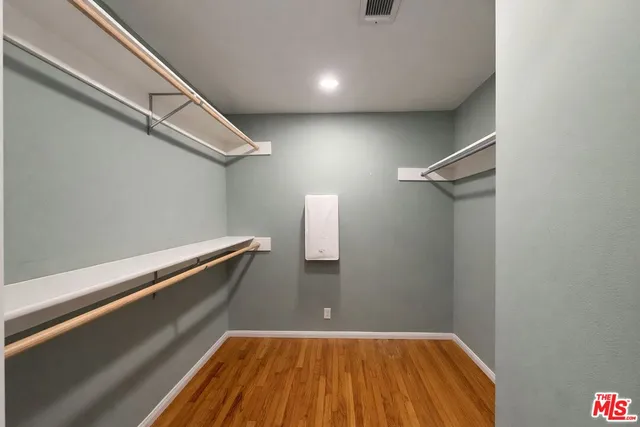 a view of a room with wooden floor and staircase