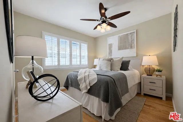 a bedroom with a bed a mirror and a window