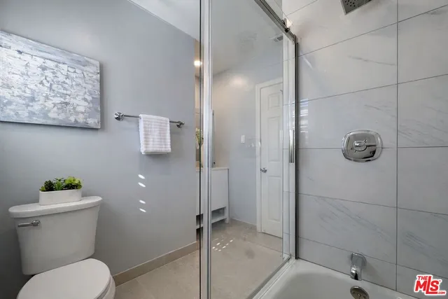 a bathroom with a toilet and a shower