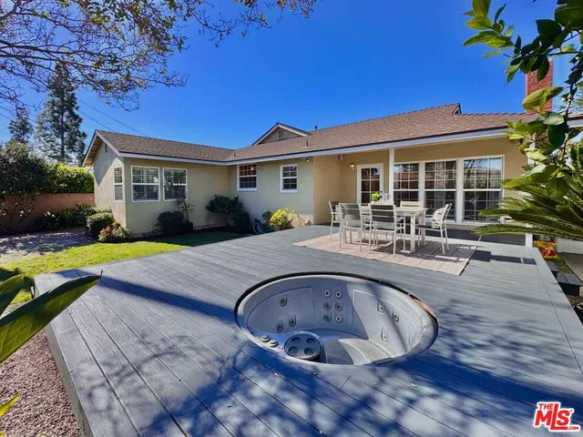 a view of a house with swimming pool and sitting area