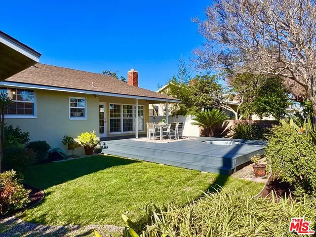 a front view of a house with garden and porch