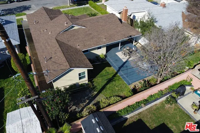 an aerial view of a house with a yard