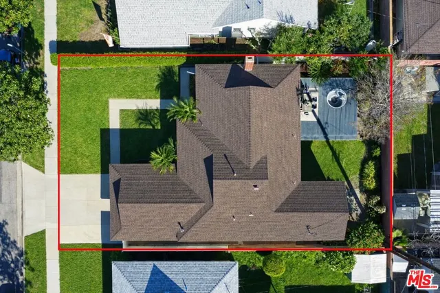 an aerial view of a house with a yard and tennis court