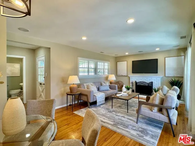 a living room with fireplace furniture and a flat screen tv
