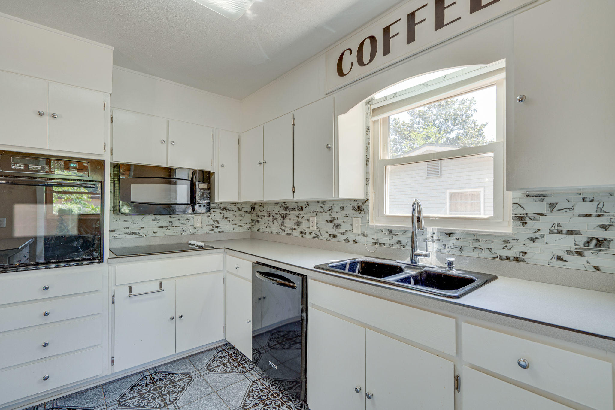 236 Deluna Road Southwest Fort Walton Beach, FL 32548 - Photo 13 of 26 a kitchen with sink cabinets and window