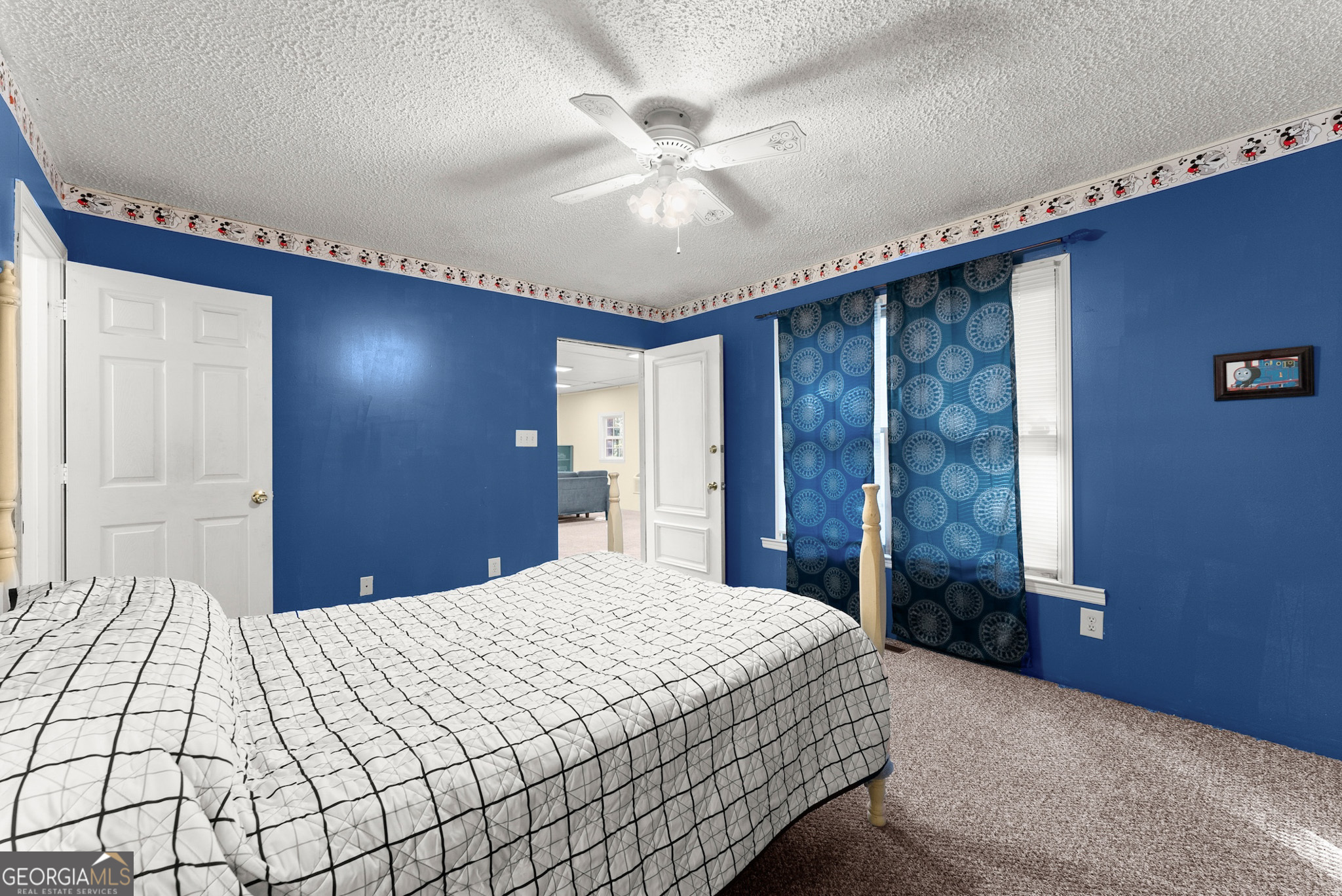 350 Old River Road Cornelia, GA 30531 - Photo 20 of 42 a bedroom with a large bed and a chandelier