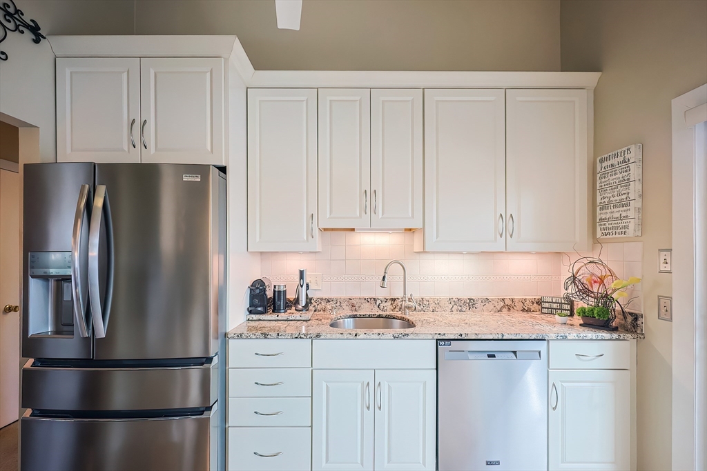 33 Debra Lane Framingham, MA 01701 - Photo 13 of 40 a kitchen with refrigerator a stove a sink and cabinets