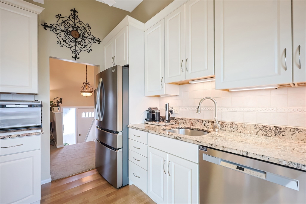 33 Debra Lane Framingham, MA 01701 - Photo 14 of 40 a kitchen with stainless steel appliances granite countertop a refrigerator and a sink