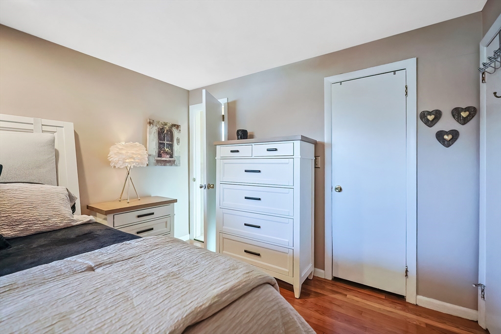 33 Debra Lane Framingham, MA 01701 - Photo 16 of 40 a bedroom with a bed and wooden floor