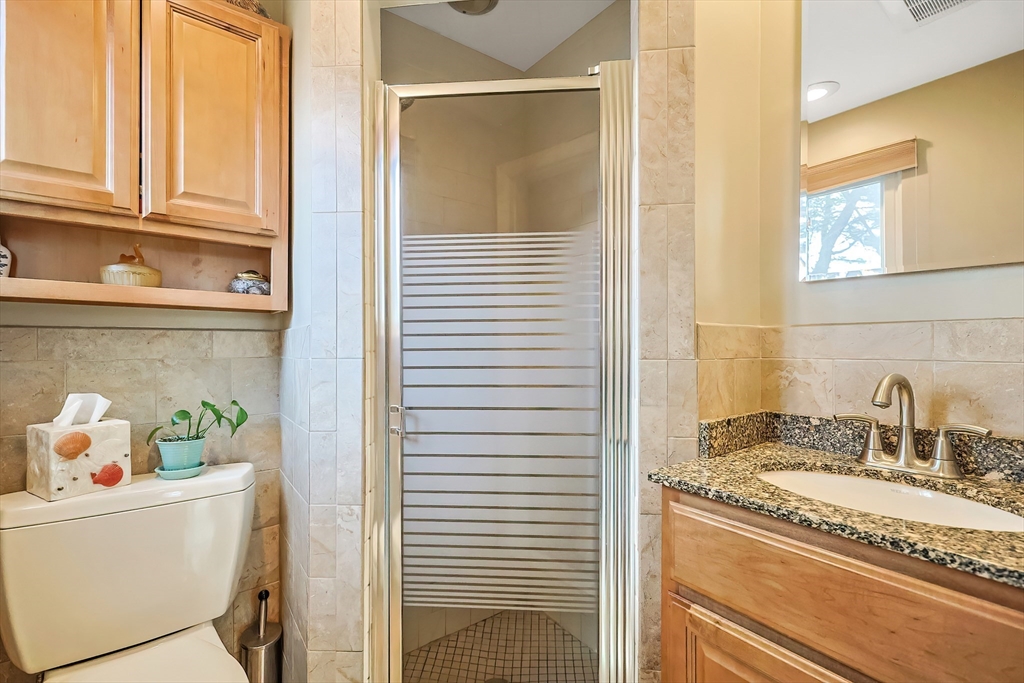 33 Debra Lane Framingham, MA 01701 - Photo 17 of 40 a bathroom with a granite countertop sink and a mirror
