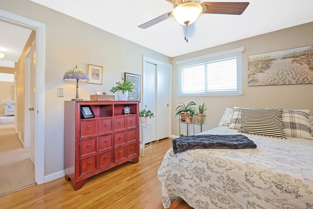 33 Debra Lane Framingham, MA 01701 - Photo 20 of 40 a bedroom with a bed and wooden floor