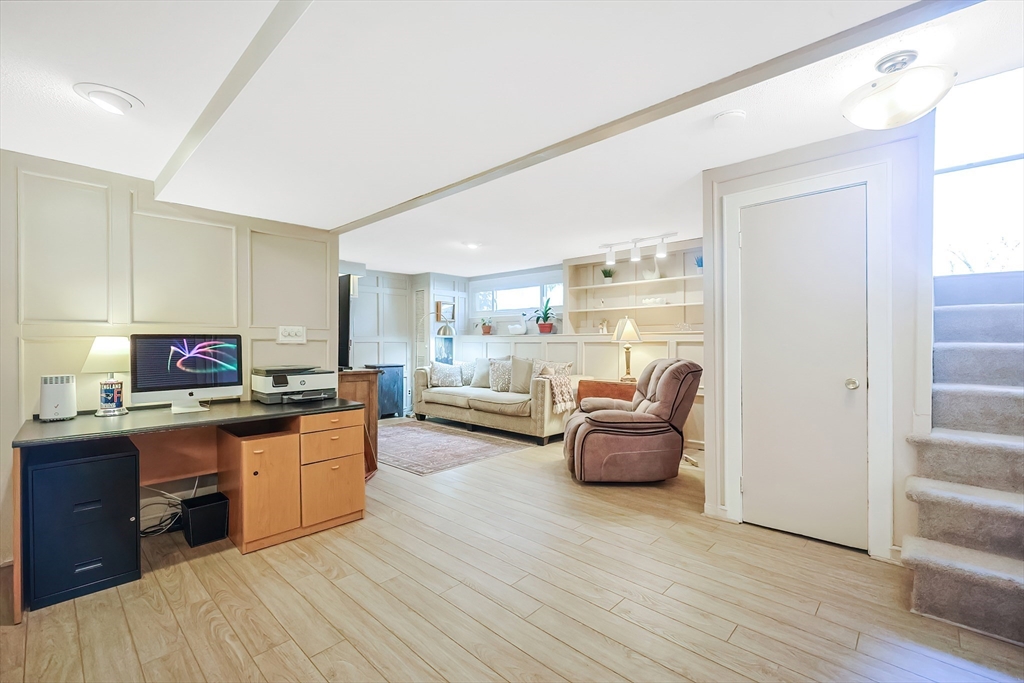 33 Debra Lane Framingham, MA 01701 - Photo 29 of 40 a living room with furniture and a kitchen