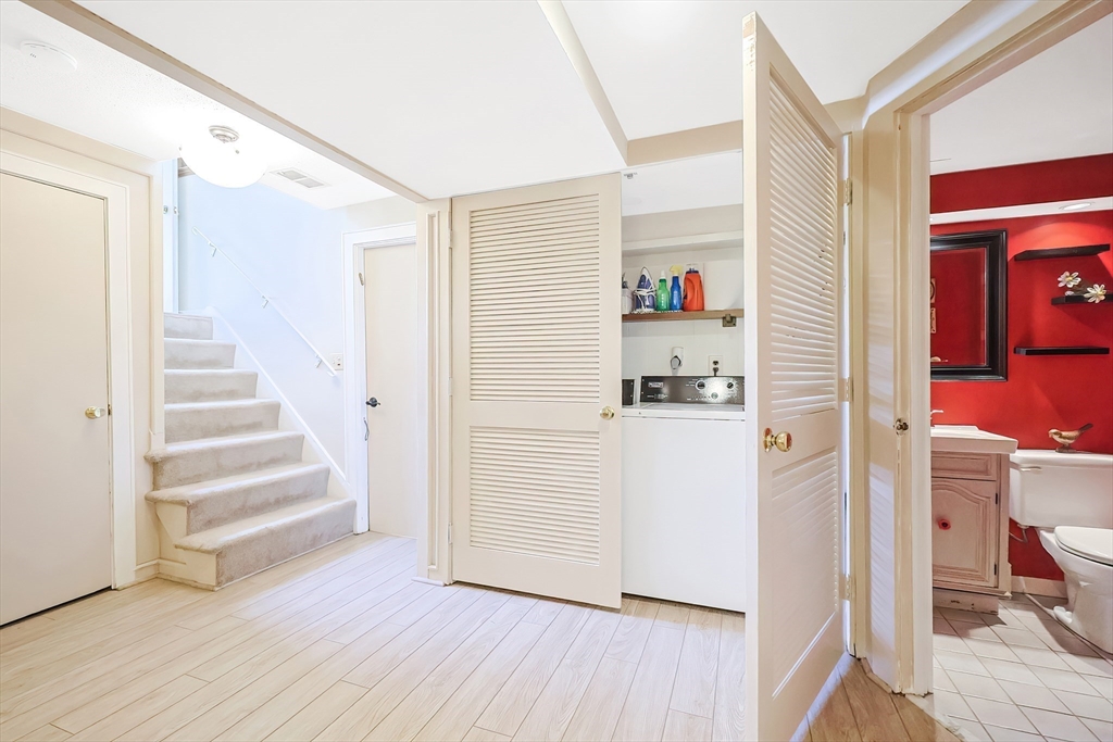 33 Debra Lane Framingham, MA 01701 - Photo 30 of 40 a view of a hallway with wooden floor and closet