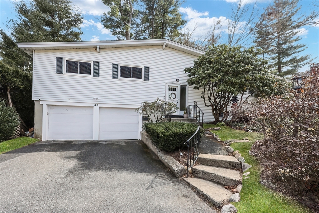 33 Debra Lane Framingham, MA 01701 - Photo 3 of 40 a front view of a house with a yard
