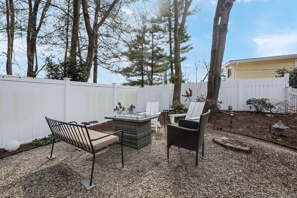 33 Debra Lane Framingham, MA 01701 - Photo 32 of 40 a view of a lounge chair and table in the backyard