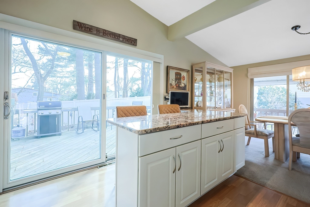 33 Debra Lane Framingham, MA 01701 - Photo 9 of 40 a kitchen with granite countertop a sink and a wooden floor