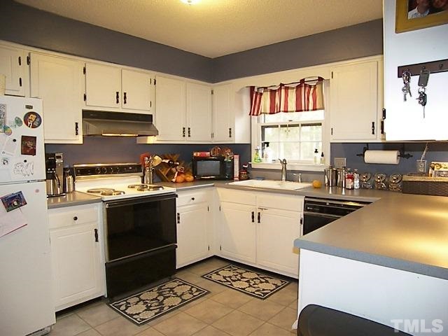 1502 Kennon Road Garner, NC 27529 - Photo 6 of 25 Lovely kitchen offers tons of cabinet space and has great natural light.