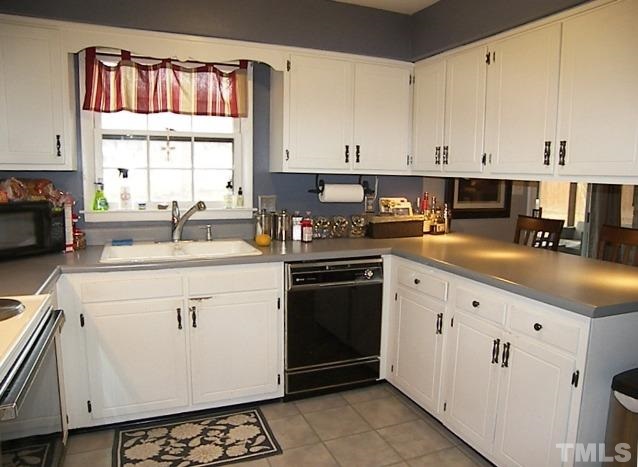 1502 Kennon Road Garner, NC 27529 - Photo 7 of 25 Kitchen also features breakfast bar and easy access for entertaining guests.