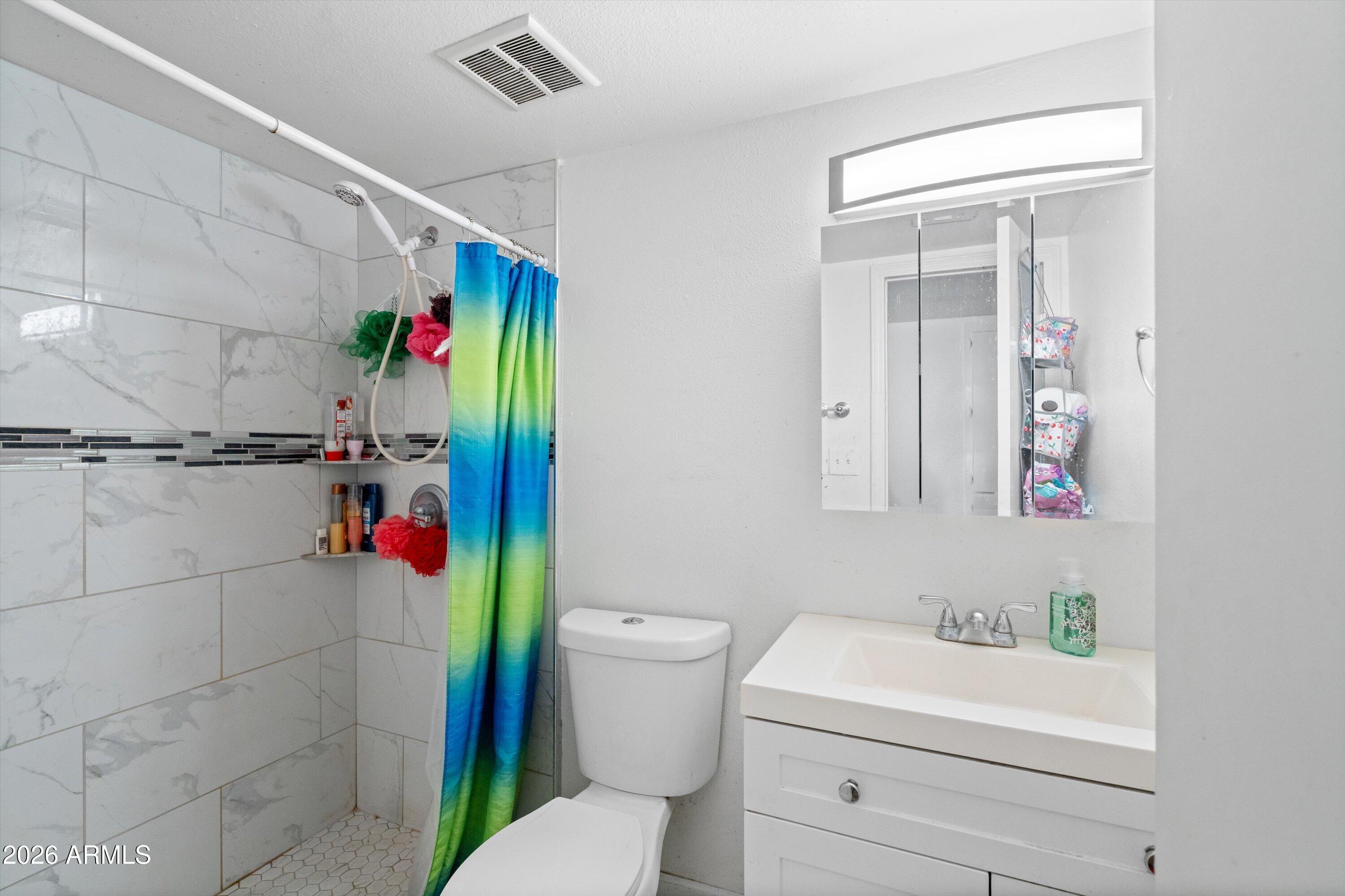 600 South Dobson Road, Unit 88 Mesa, AZ 85202 - Photo 16 of 18 a bathroom with a sink toilet and shower
