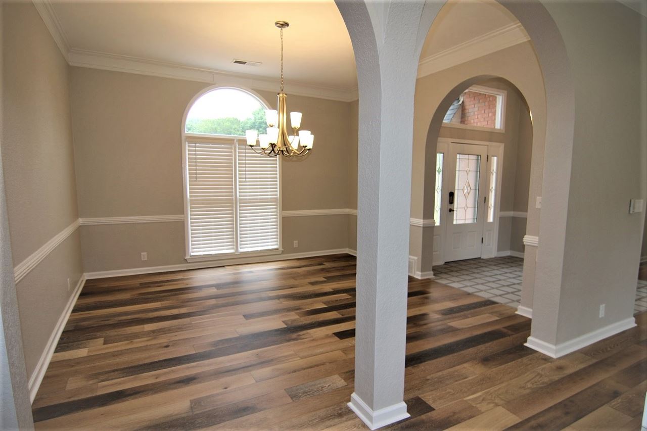 680 Beckett Ridge Cove Collierville, TN 38017 - Photo 3 of 25 Keeping with the Modern theme the dining space was adorned with this modern fixture and the newly replaced double pane windows are shielded with new 2 1/2" faux wood blinds to protect the inside from the bright afternoon sun.